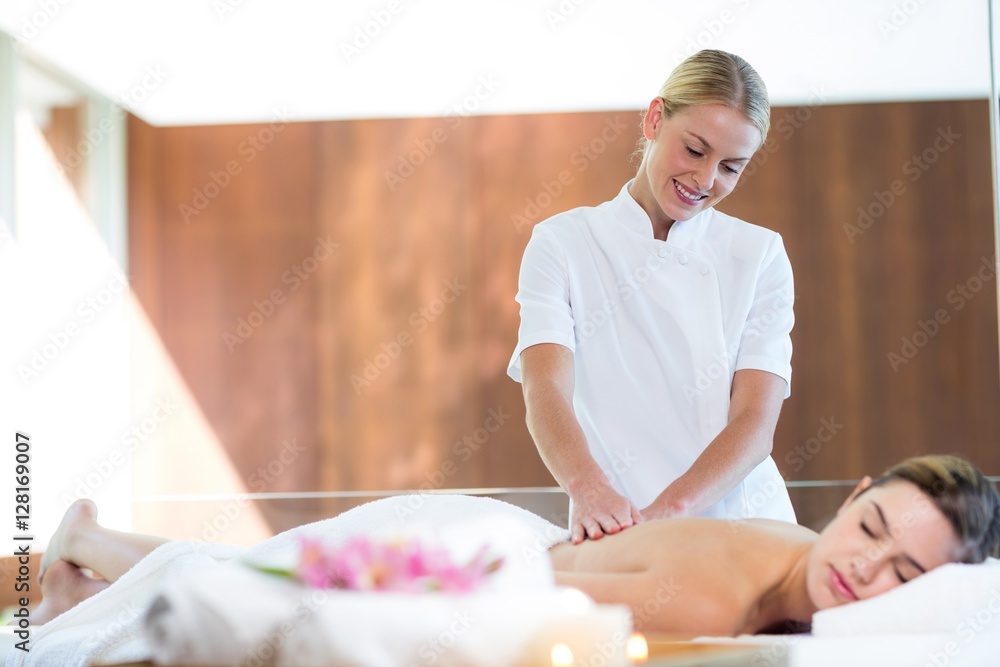 Woman receiving a back massage - obrazy, fototapety, plakaty 