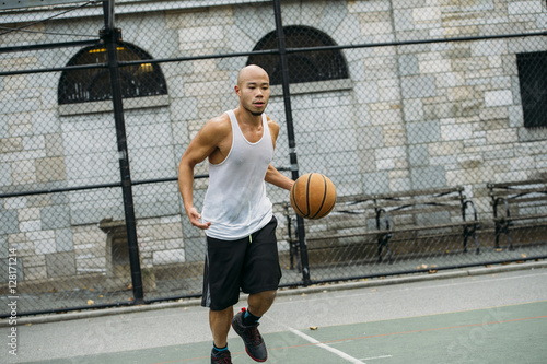 Man playing basketball on court photo