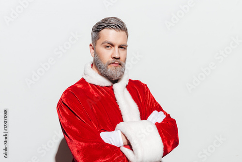 Confident man santa claus standing with hands folded