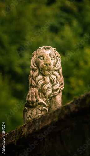 A stone lion sculpture in a Romanian town