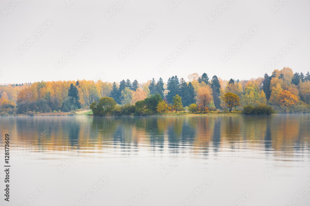 Raspberry island on lake Senezh in Solnechnogorsk fall in the fog in calm weather. Autumn water landscape