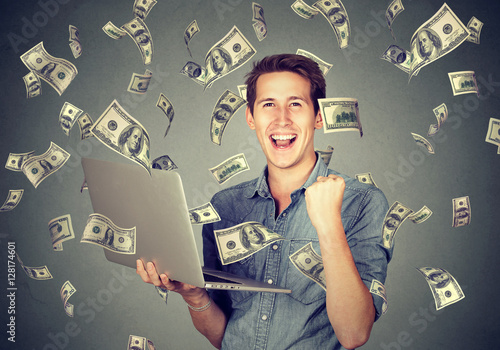 Fotografie Successful man using laptop building online business making money