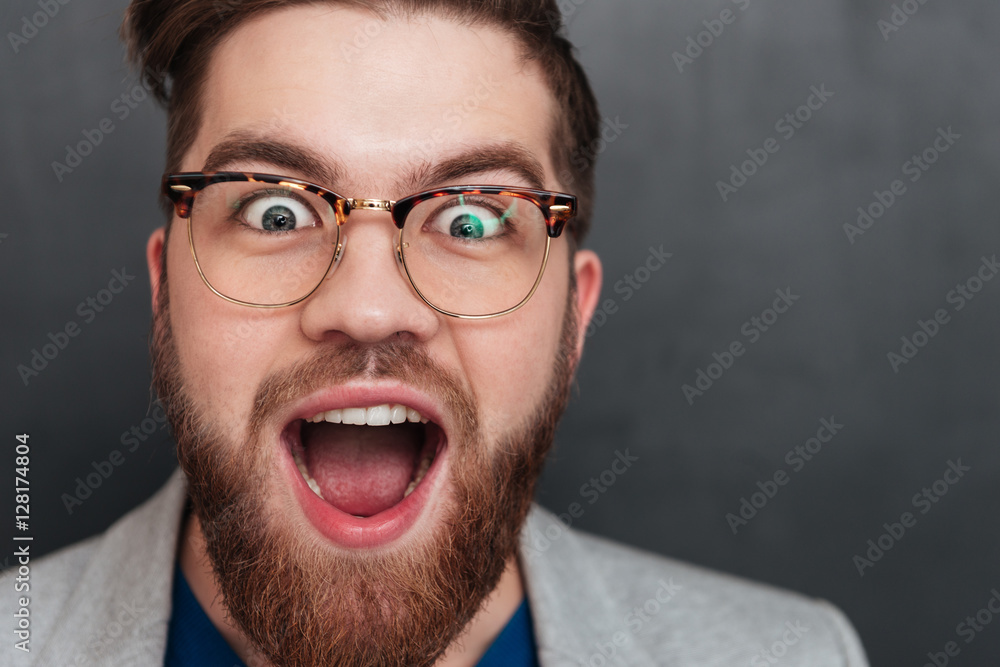 Surprised happy young businessman in glasses with opened mouth Surprised happy young businessman in glasses with opened mouth