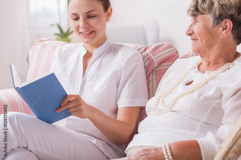 Elderly lady and nurse reading Elderly lady and nurse reading