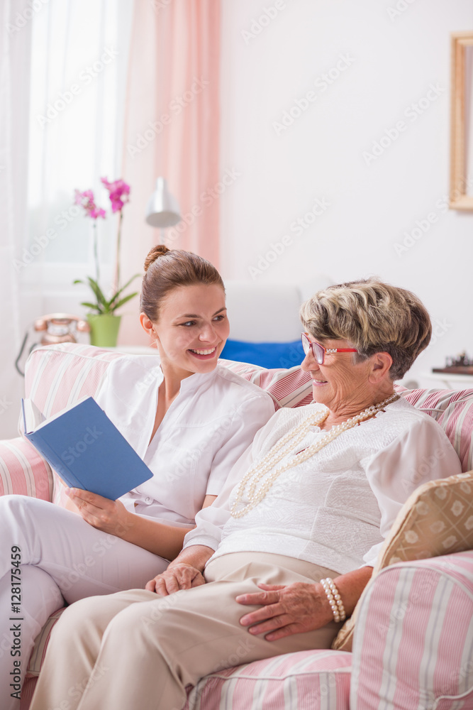 Senior patient and nurse with book Senior patient and nurse with book