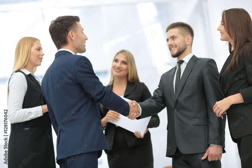 Business partner greeting each other with handshake Business partner greeting each other with handshake