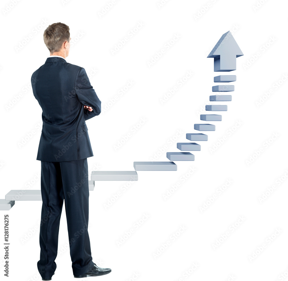 Fototapeta premium Young businessman looking at a ladder