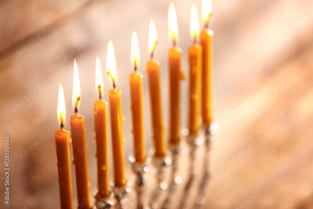 Menorah with candles for Hanukkah on blurred wooden background, close up Menorah with candles for Hanukkah on blurred wooden background, close up