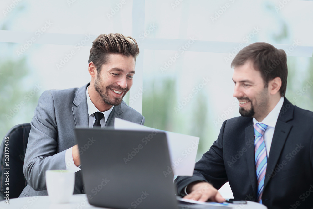 Business men discussing together in an office Business men discussing together in an office