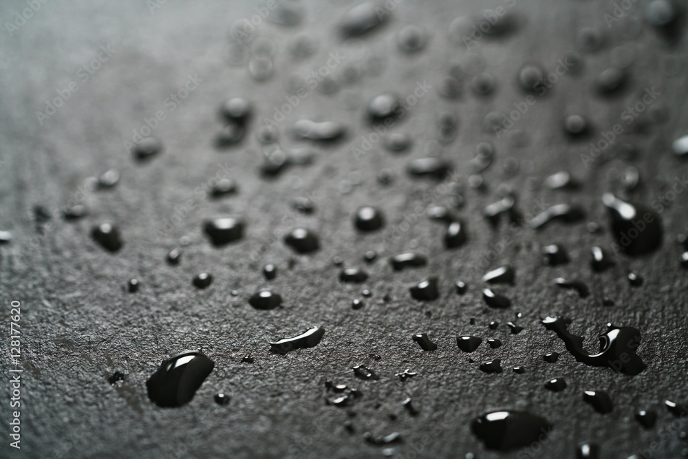 slate surface with water drops macro shot, shallow focus