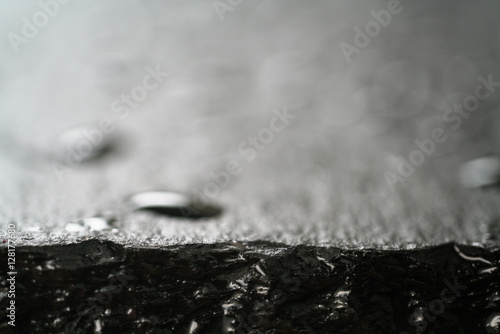 slate surface with water drops macro shot, shallow focus