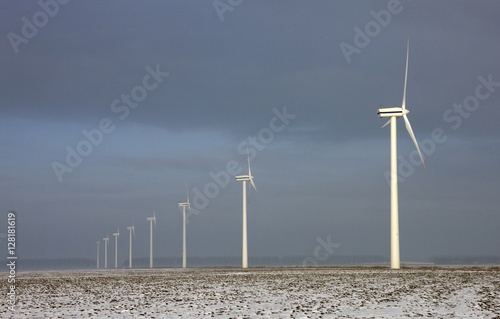 Windmill. Wind energy. Green energy. Winter landscape. Flevopolder Netherlands. Snow on the fields. photo