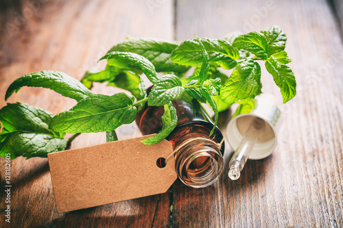 Photography Fresh peppermint and oil on wooden background