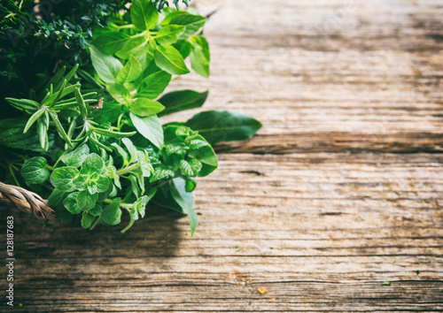 Obraz na plátně Variety of herbs on wooden background
