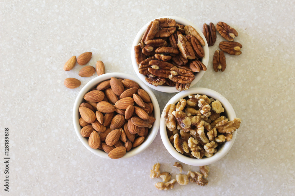 Almonds, Pecans, And Walnuts in Containers on Kitchen Countertop Almonds, Pecans, And Walnuts in Containers on Kitchen Countertop