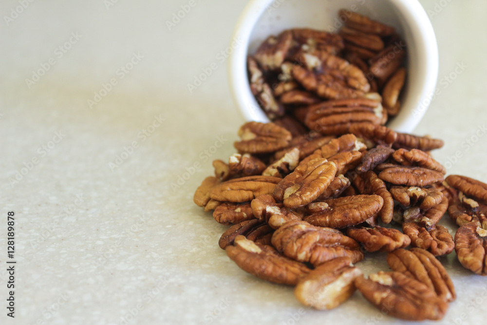 Pecans Spilling Out Of A Container, Positioned Off Right Edge Pecans Spilling Out Of A Container, Positioned Off Right Edge