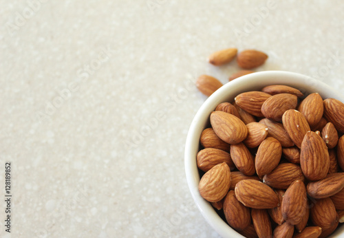 Almonds in Container on Kitchen Countertop, Positioned Off Botto photo