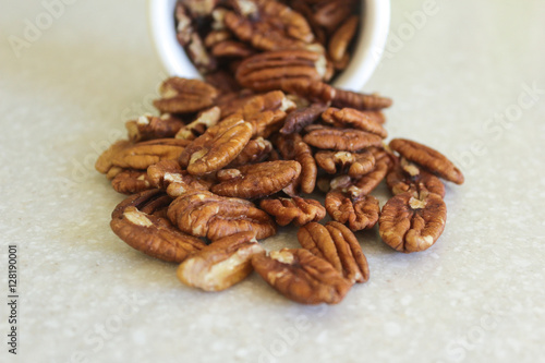 Pecans Spilling Out Of A Container, Centered