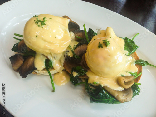 eggs forestiere a variation of eggs benedict, poached eggs, hollandaise sauce, muffin, mushrooms and spinach. Mobilestock photo