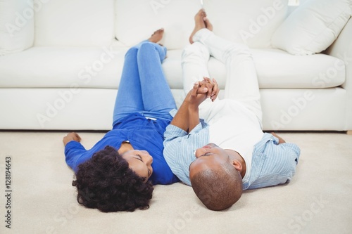 Smiling couple lying on the floor