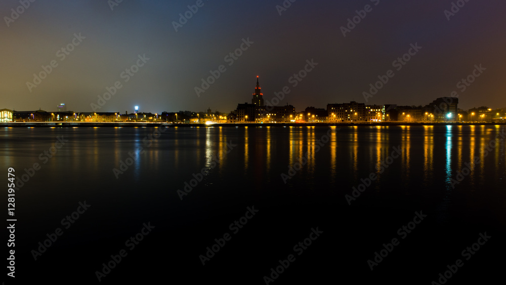 summer night city light reflections over water