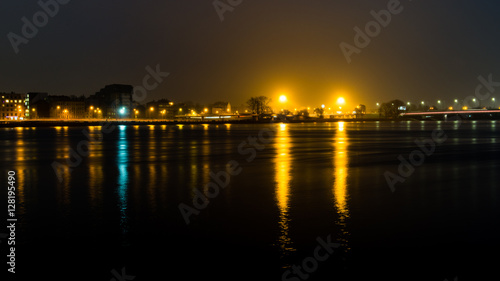 summer night city light reflections over water