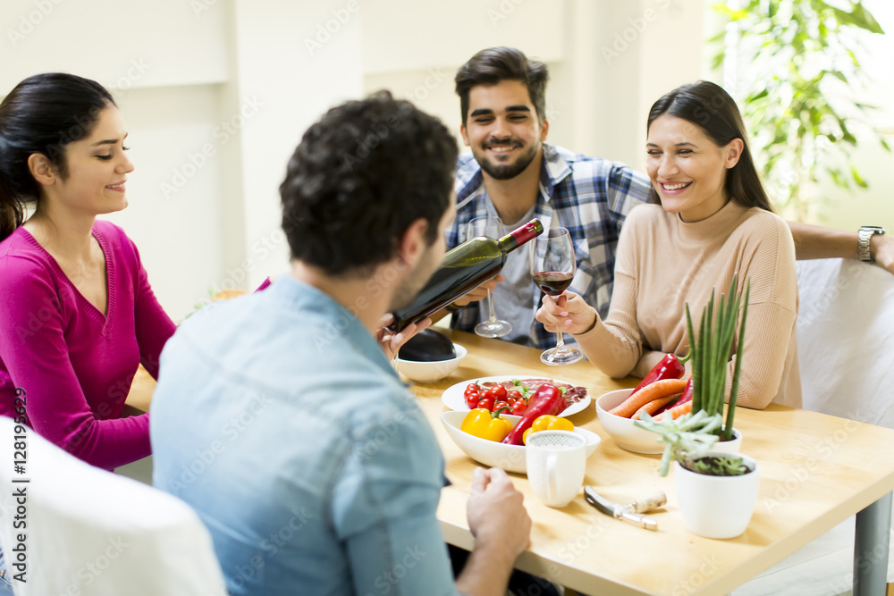 Young people sitting by the table