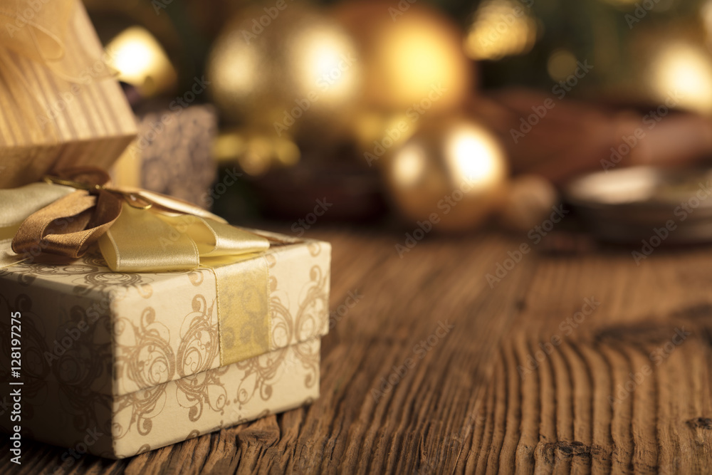 Golden Christmas decoration. Presents in boxes on a wooden background with copy space. Golden baubles. Christmas theme. Golden and brownish aesthetics. Christmas spices. Golden Christmas decoration. Presents in boxes on a wooden background with copy space. Golden baubles. Christmas theme. Golden and brownish aesthetics. Christmas spices.