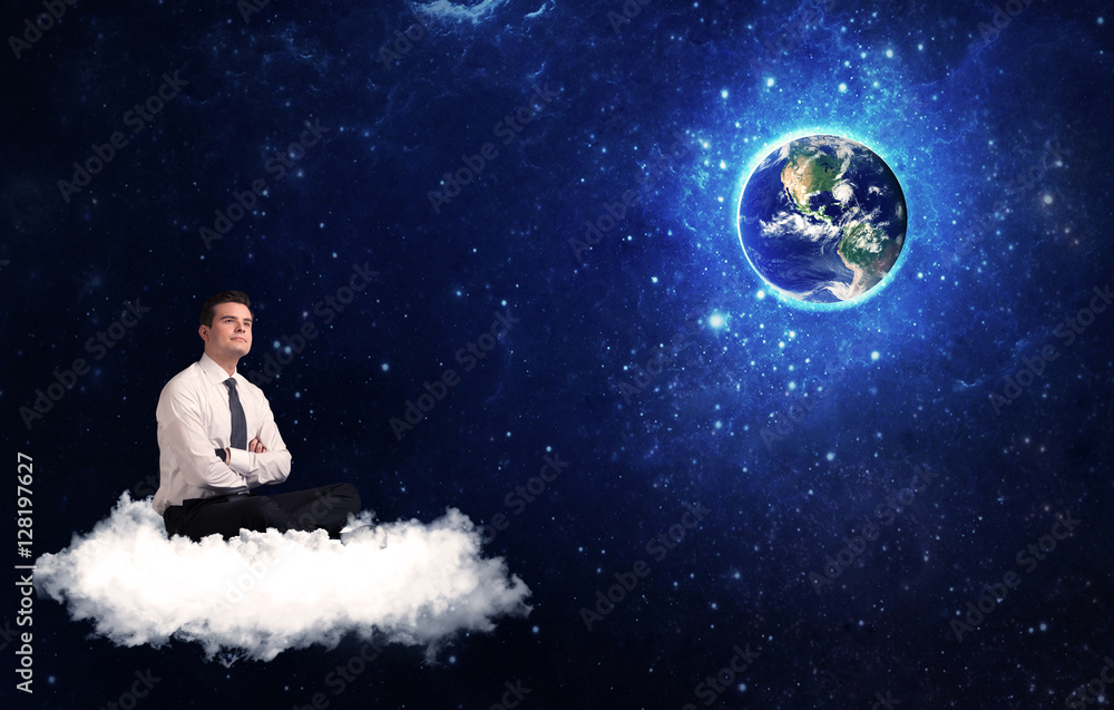 Fototapeta premium Man sitting on cloud looking at planet earth
