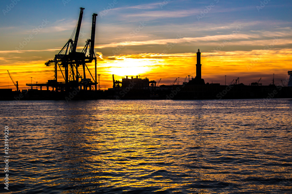 sunset at Genoa's port, silhouette of the Lanterna, Italy