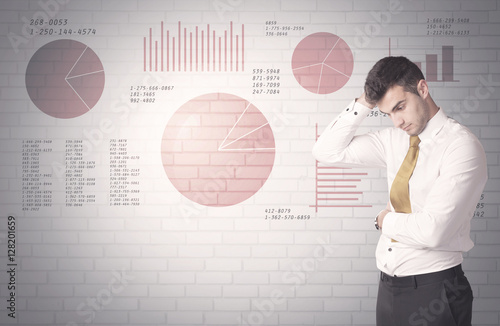 Pie charts and numbers on wall with salesman