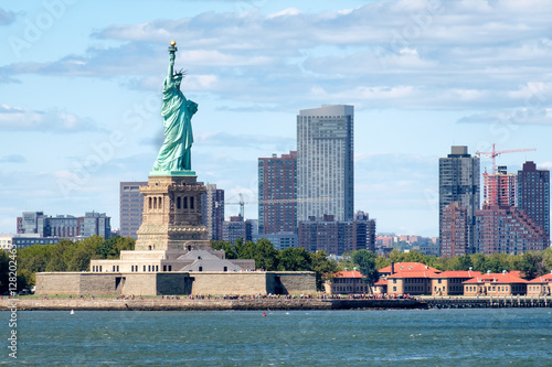 The Statue of Liberty in New York with skyscrapers on the background