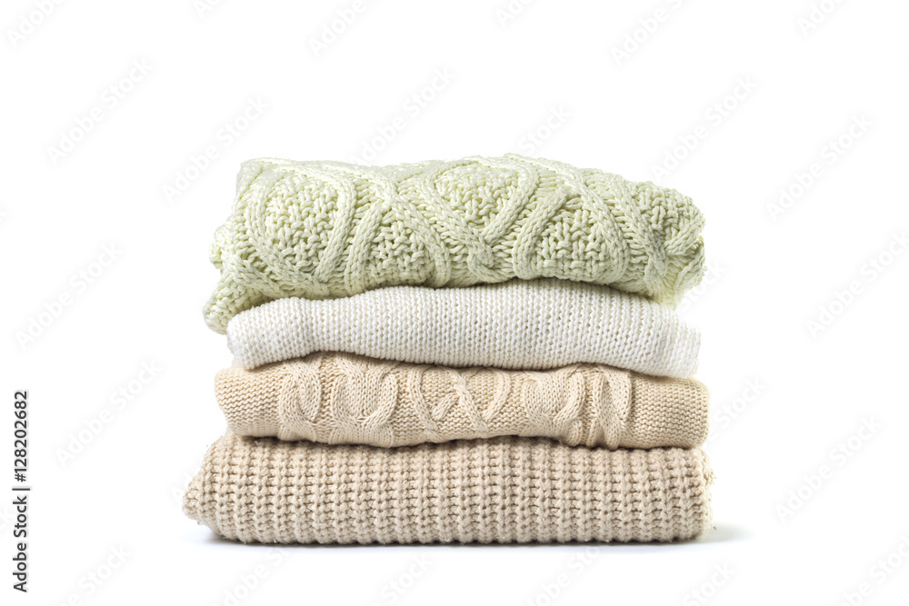 Stack of various sweaters isolated on white background - obrazy, fototapety, plakaty 