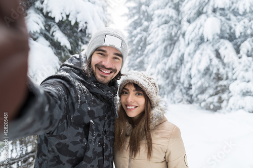 Man Taking Selfie Photo Young Romantic Couple Smile Snow Forest Outdoor Winter Pine Woods
