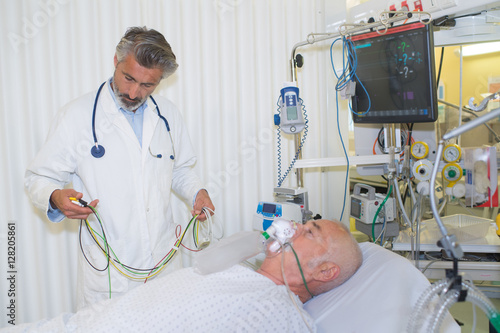 senior doctor with his sick patient photo