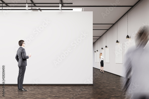 Business people in an art gallery with dark wood floor