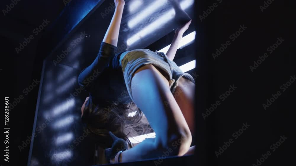 Sexy brunette dances on blue dark background. Beautiful girl dancing, laying on cube. Shot on RED EPIC DRAGON Cinema Camera in slow motion. Sexy brunette dances on blue dark background. Beautiful girl dancing, laying on cube. Shot on RED EPIC DRAGON Cinema Camera in slow motion.