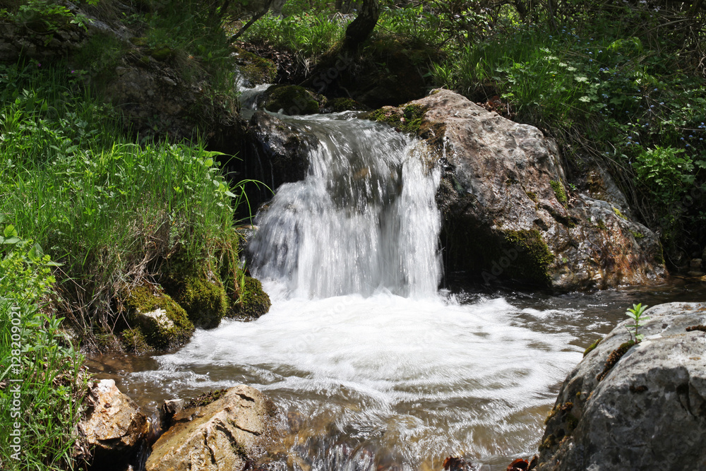 Small waterfall flow in Cerna Mountains, Romania Small waterfall flow in Cerna Mountains, Romania