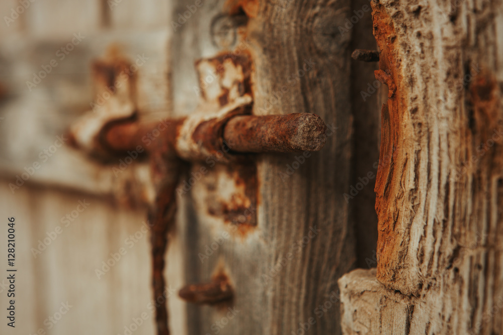 Closed rusty on an wooden door Closed rusty on an wooden door