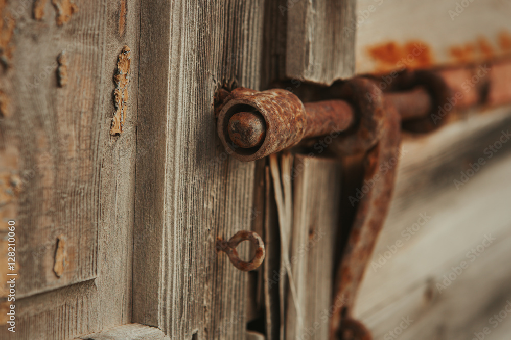 Closed rusty on an wooden door Closed rusty on an wooden door