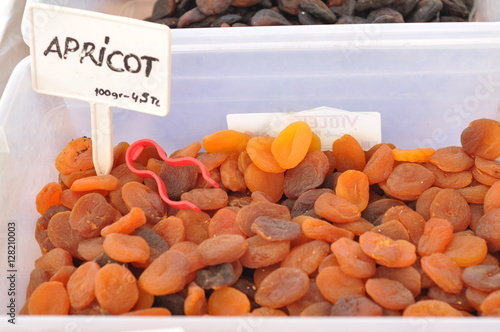 Many dried apricots sold on open farmer's market. Texture, background