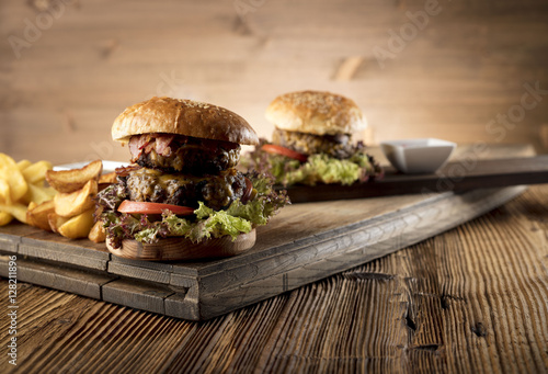 Fresh home-made hamburger served on wood, place for typography