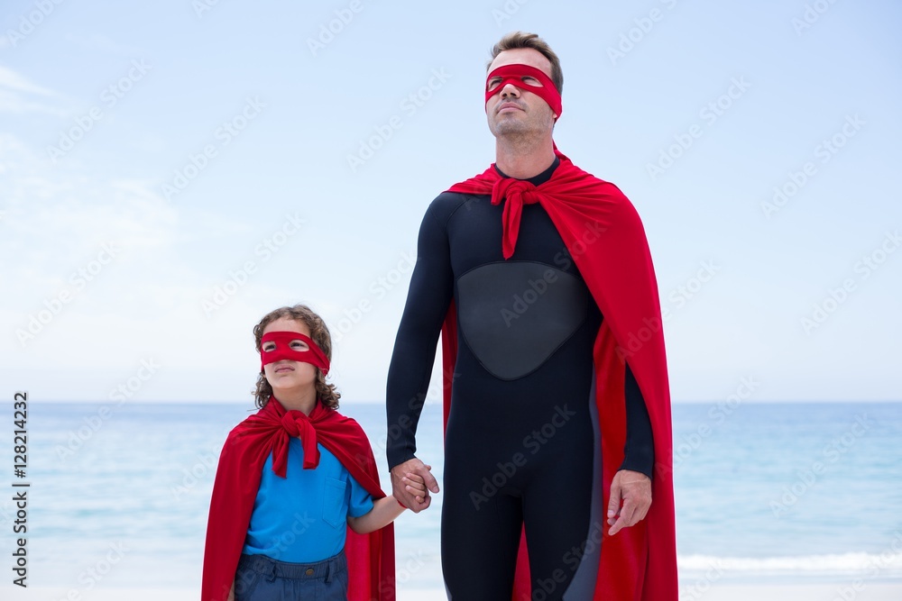 Father and daughter in superhero costume sea shore Father and daughter in superhero costume sea shore