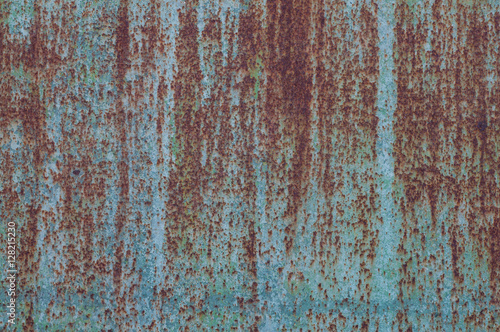 Rusted blue painted metal wall.