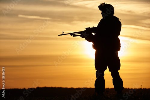 Military soldier silhouette with machine gun