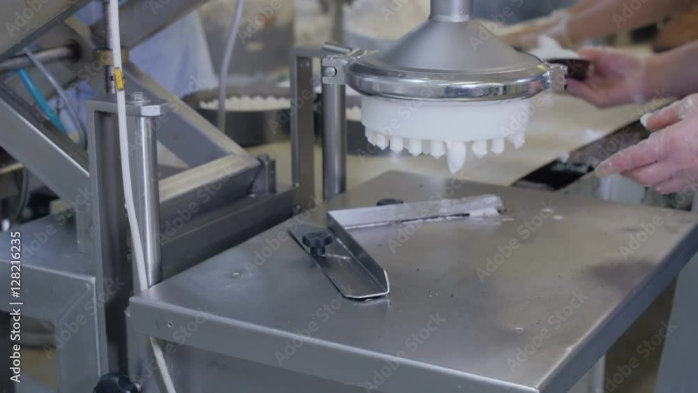 Automated cake production machine. Confectioners working on cakes producing equipment in bakery, cake production line. 4K. Automated cake production machine. Confectioners working on cakes producing equipment in bakery, cake production line. 4K.