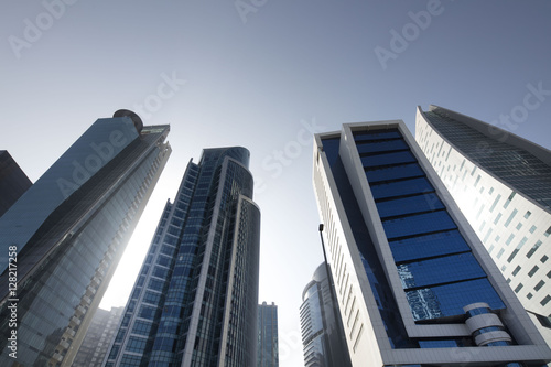 Buildings in perspective. Wide angle shot from bellow. Blue sky. Modern architecture.