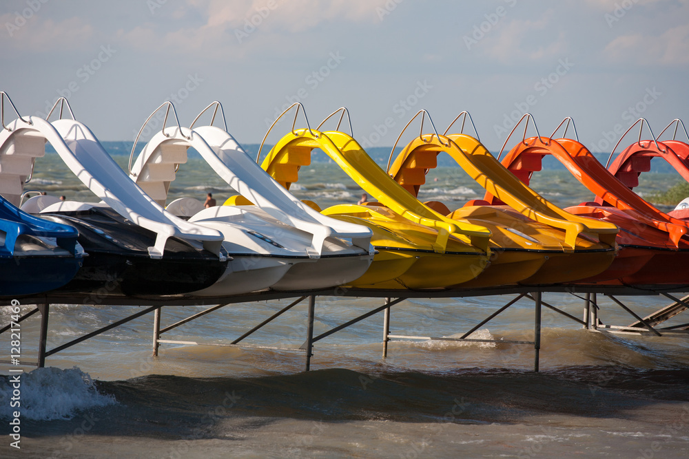 Row of paddle boats at lake Balaton beach, Hungary