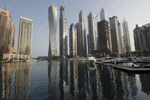Architecture theme. Panoramic view with modern skyscrapers and water pier of Dubai Marina at sunrise   United Arab Emirates. Luxurious property.