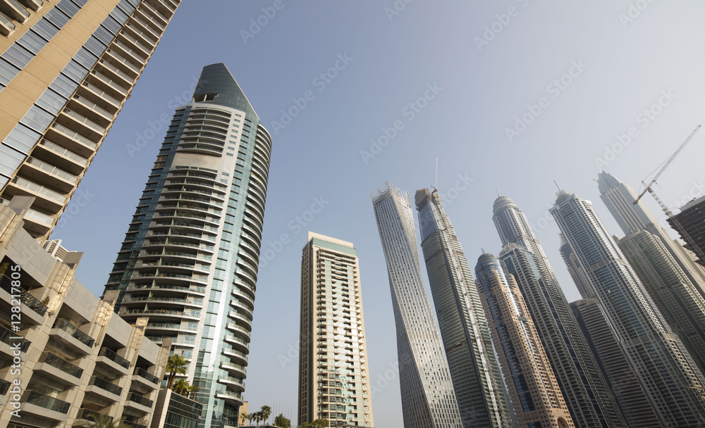 Architecture theme. Panoramic view with modern skyscrapers and water pier of Dubai Marina at sunrise,, United Arab Emirates. Luxurious property. Architecture theme. Panoramic view with modern skyscrapers and water pier of Dubai Marina at sunrise,, United Arab Emirates. Luxurious property.